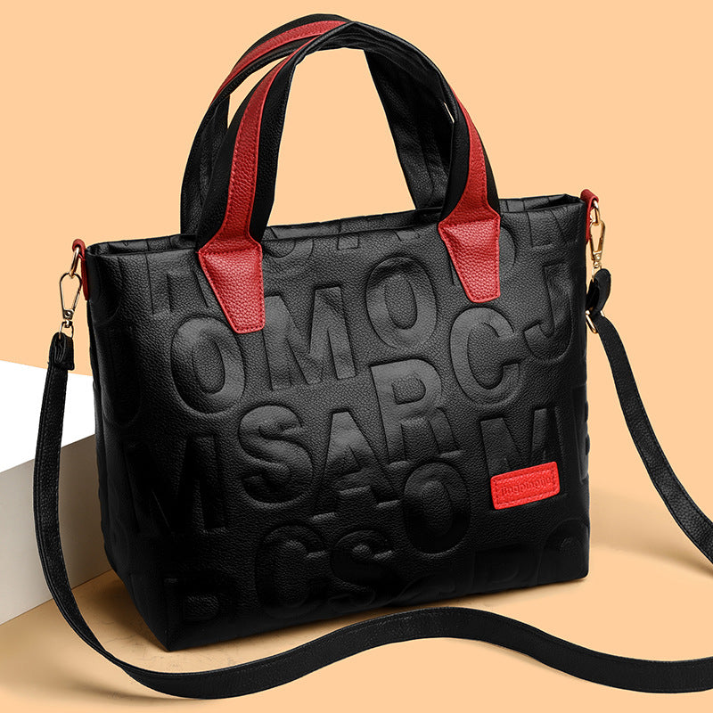 Women's structured tote bag with embossed pattern and multiple straps